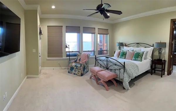 a bedroom with furniture and a flat screen tv