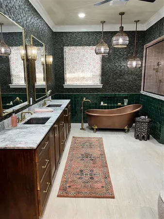 a bathroom with a granite countertop sink and a large mirror