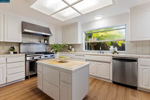 a kitchen with a stove a sink and a refrigerator