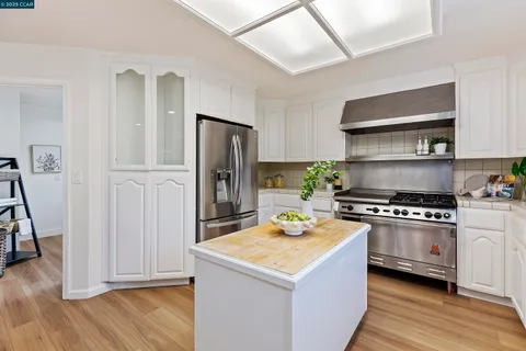a kitchen with a stove and a refrigerator