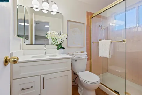 a bathroom with a sink toilet and shower