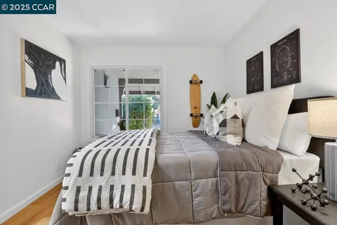 a bedroom with a bed and wooden floor