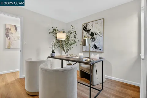 a living room with furniture a window and a potted plant