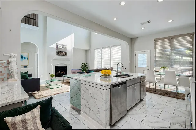 a kitchen with stainless steel appliances kitchen island granite countertop a sink and a stove