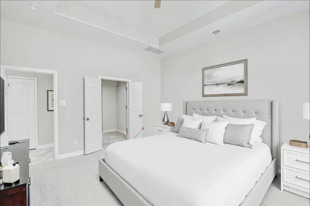 a bedroom with a bed and a painting