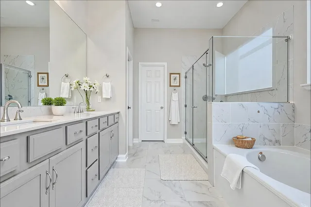 a bathroom with a tub sink and mirror