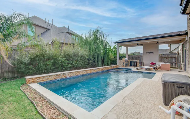 a view of a swimming pool with a patio