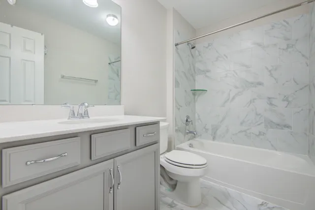 a bathroom with a sink a toilet and a bathtub