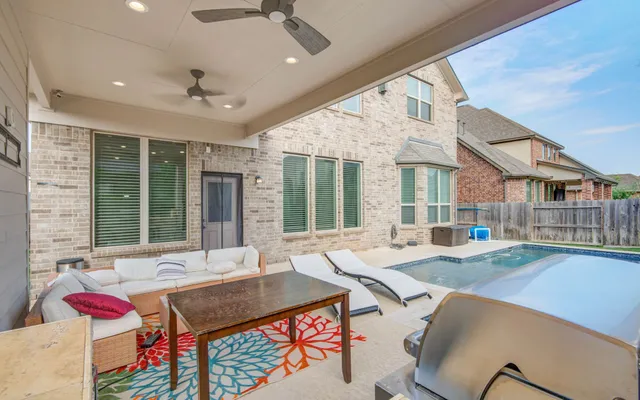 a living room with fireplace furniture and a large window