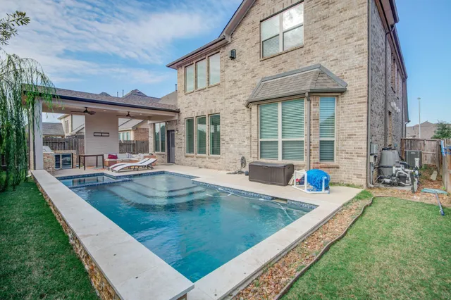 a view of a house with a backyard porch and sitting area