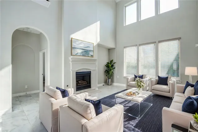 a living room with furniture fireplace and a large window
