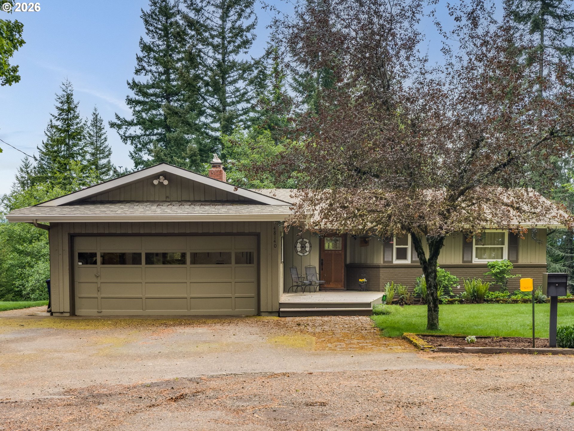 48140 Southeast Linhart Butte Road Sandy, OR 97055 - Photo 1 of 47 a front view of a house with a garden