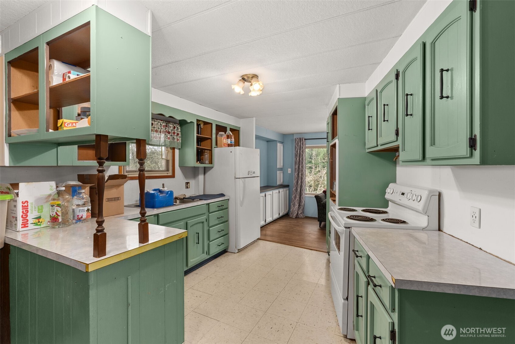 2700 Mallis Landing Road Raymond, WA 98577 - Photo 14 of 33 a kitchen with a sink stove and cabinets