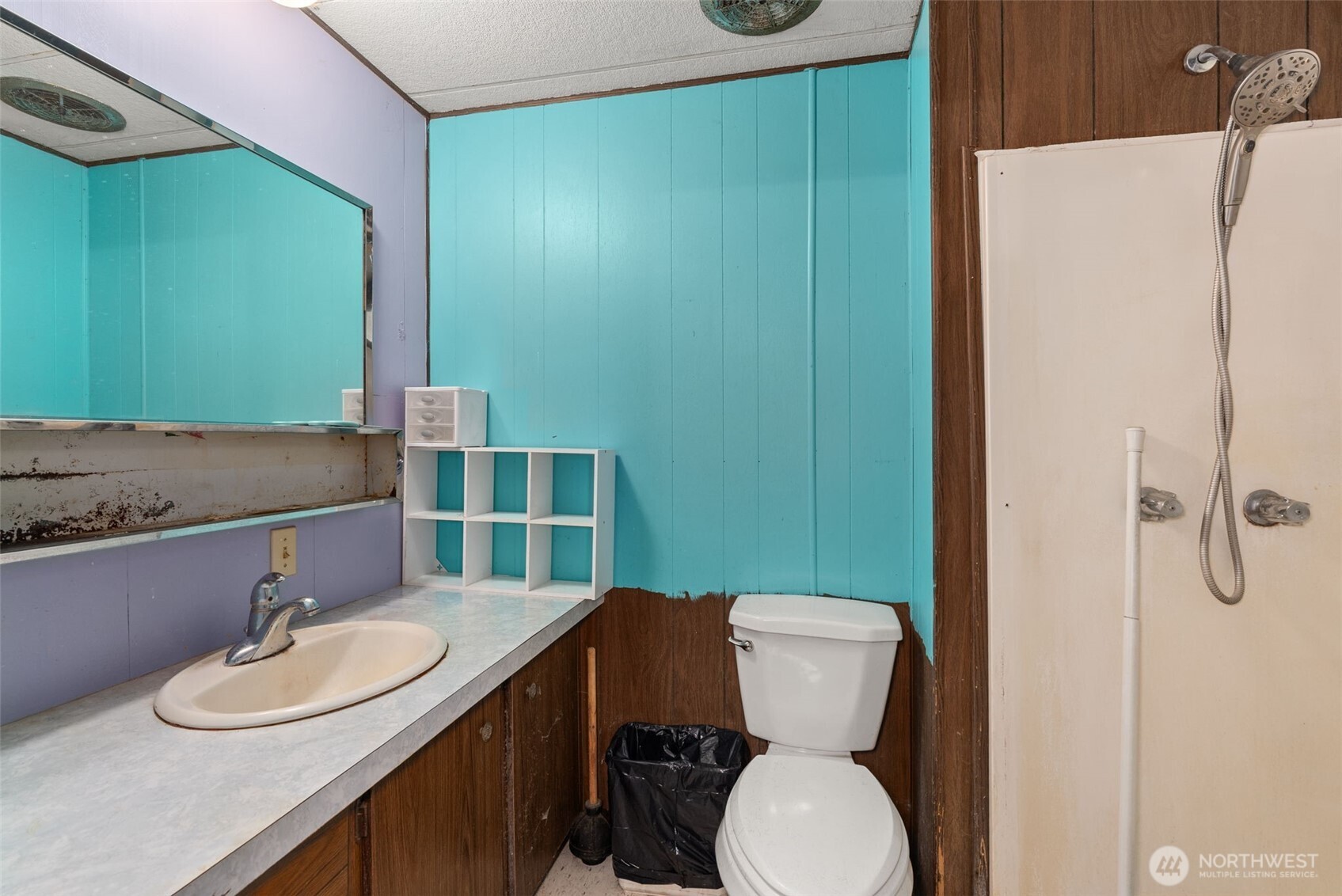 2700 Mallis Landing Road Raymond, WA 98577 - Photo 19 of 33 a bathroom with a granite countertop toilet sink and mirror