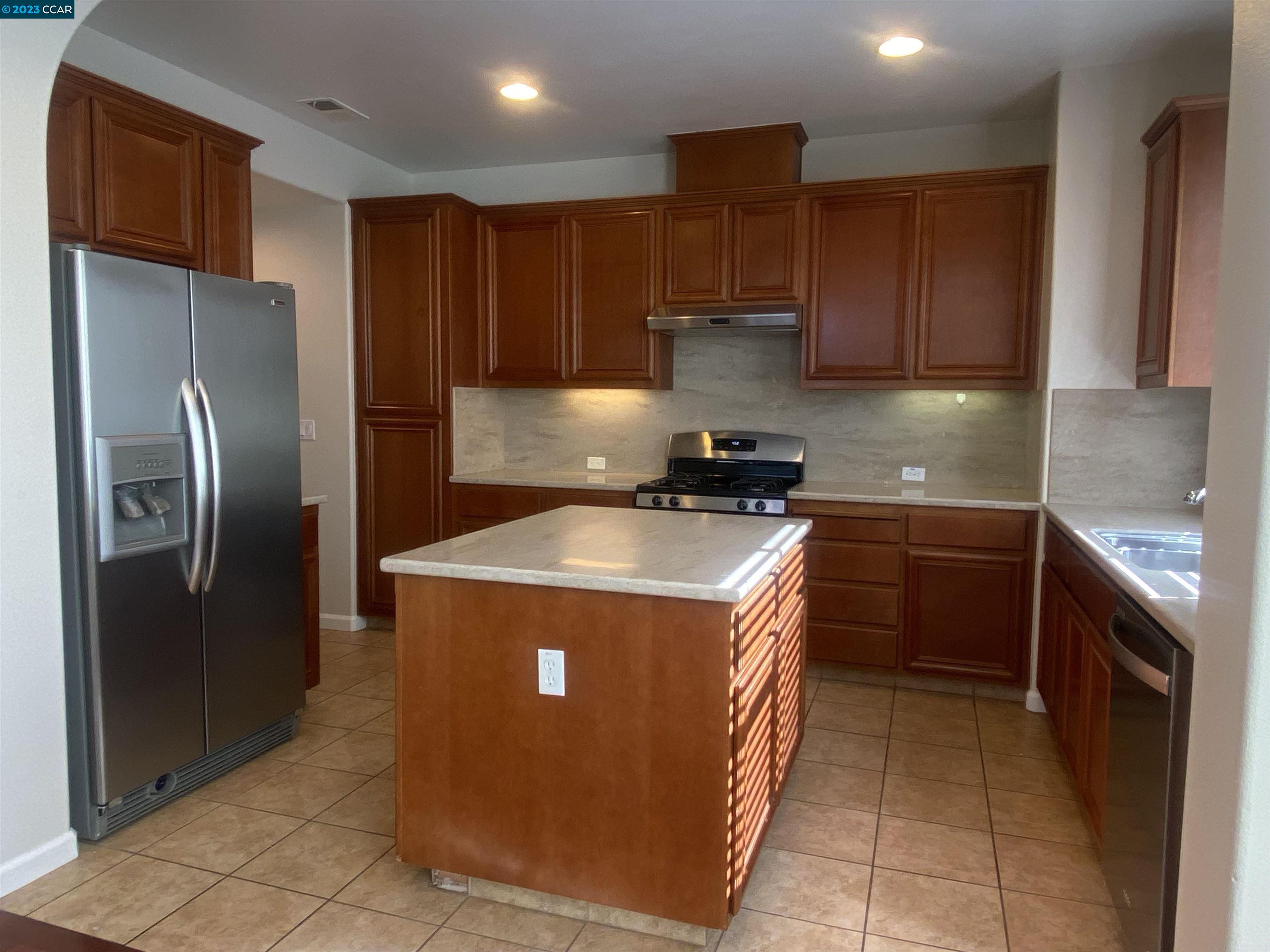 1016 Cedarwood Loop San Ramon, CA 94582 - Photo 3 of 8 a kitchen with stainless steel appliances granite countertop a refrigerator a stove a sink and a oven