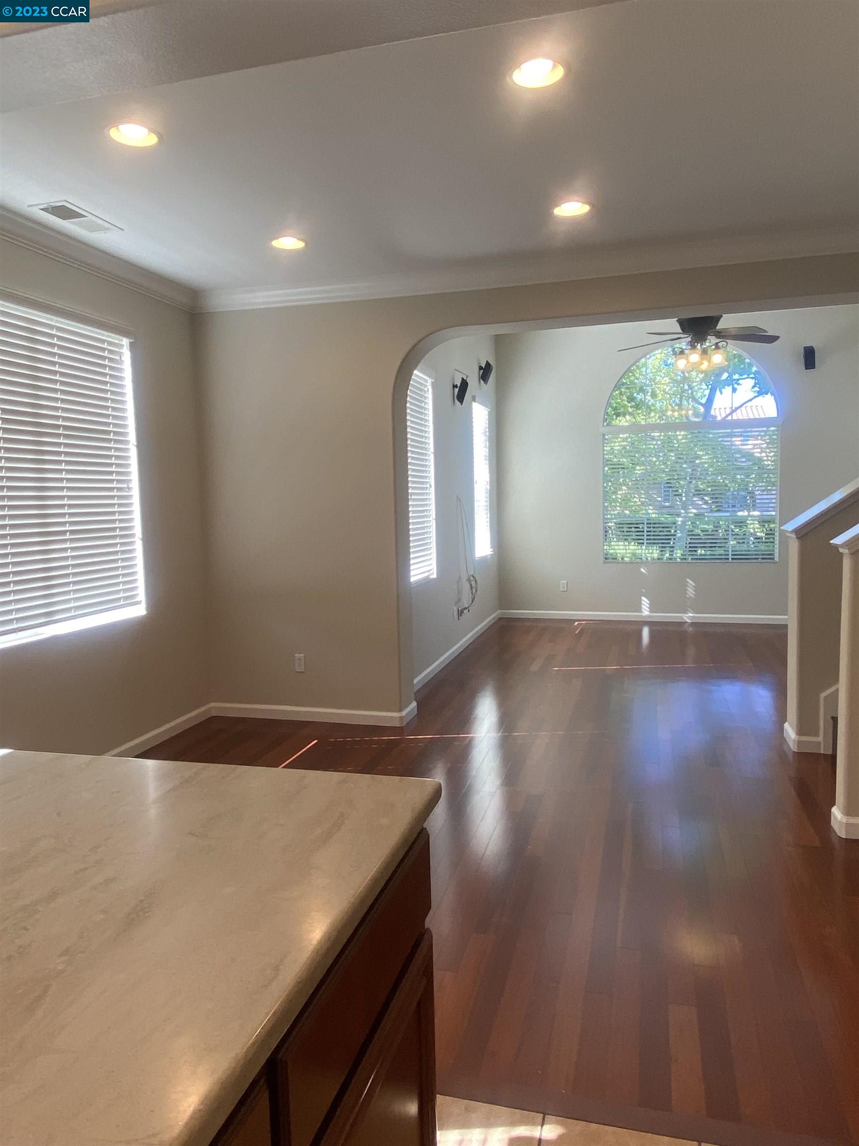 1016 Cedarwood Loop San Ramon, CA 94582 - Photo 5 of 8 a view of an empty room with wooden floor and a window