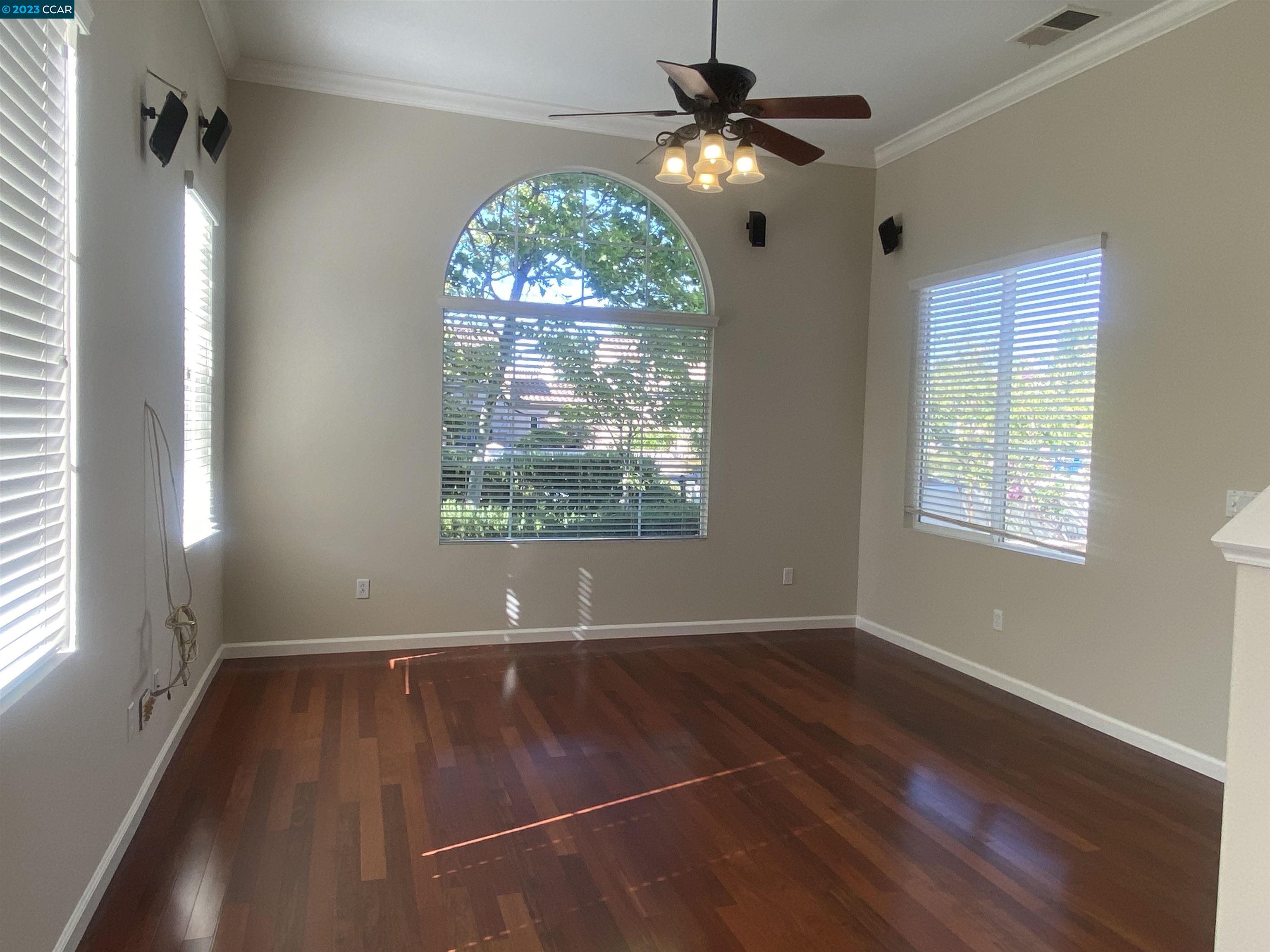 1016 Cedarwood Loop San Ramon, CA 94582 - Photo 8 of 8 an empty room with wooden floor fan and windows