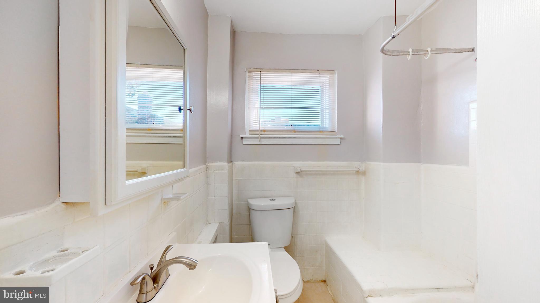 2415 80th Avenue Philadelphia, PA 19150 - Photo 11 of 35 a white toilet sitting next to a bathroom sink