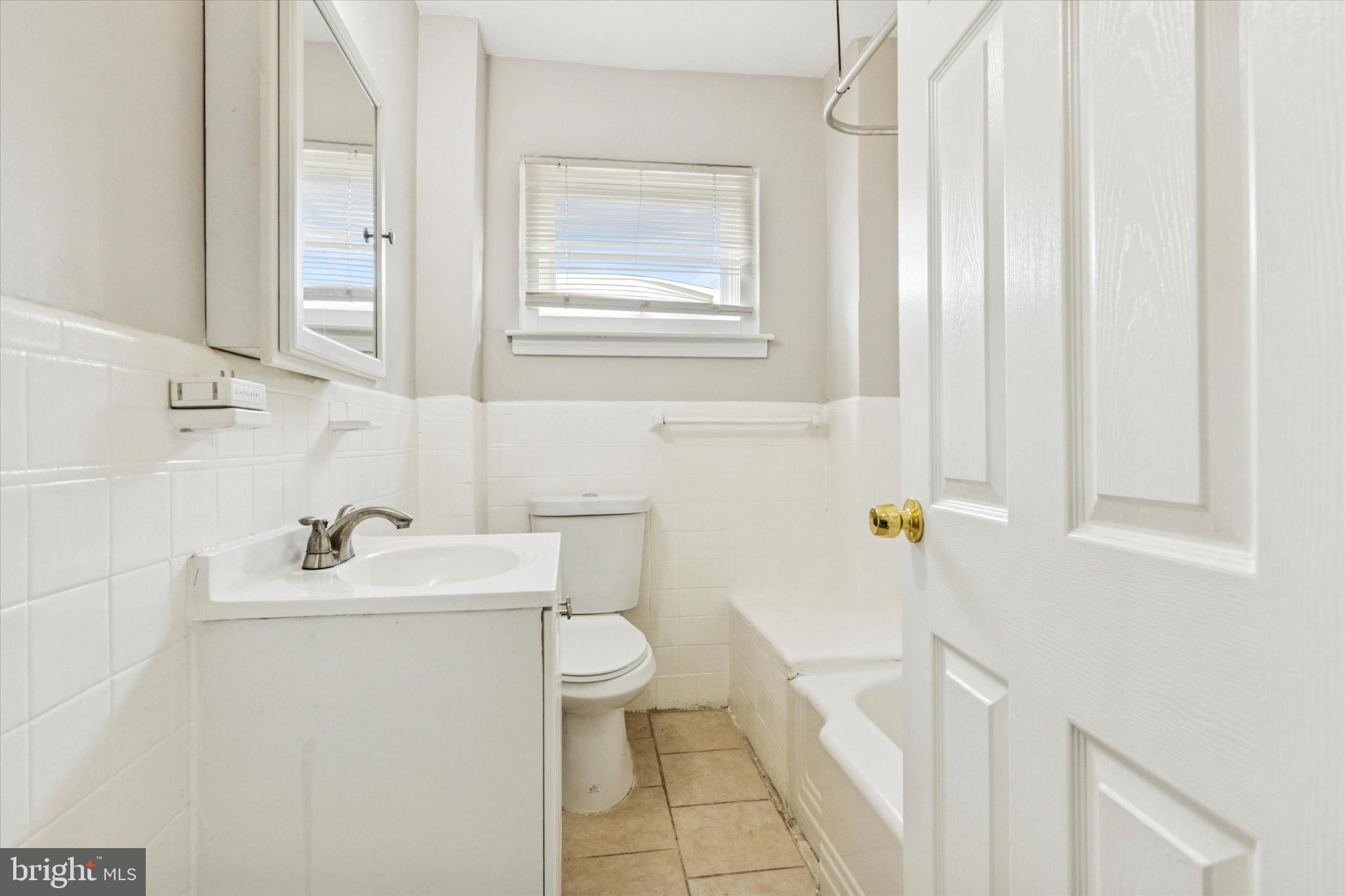 2415 80th Avenue Philadelphia, PA 19150 - Photo 20 of 35 a bathroom with a sink a toilet and a bathtub