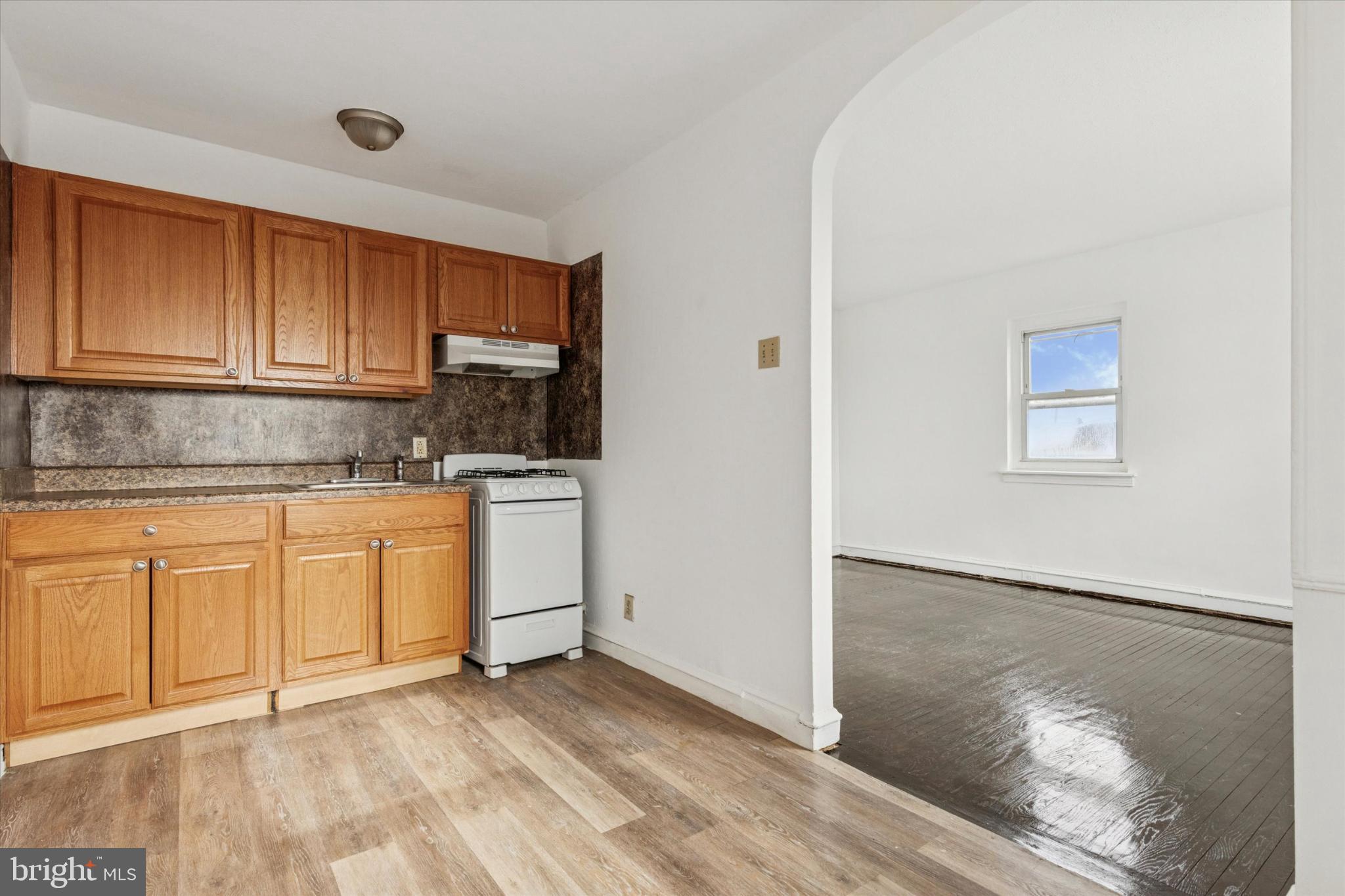 2415 80th Avenue Philadelphia, PA 19150 - Photo 33 of 35 a kitchen with granite countertop white cabinets and white appliances