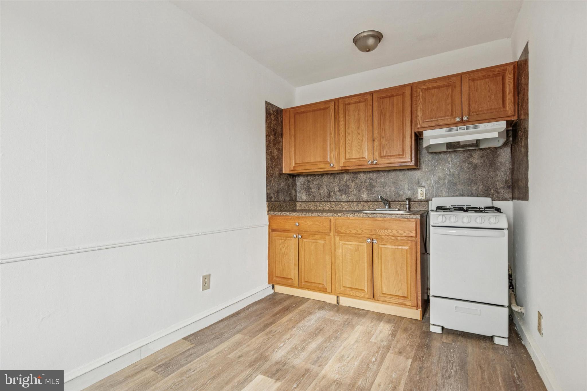 2415 80th Avenue Philadelphia, PA 19150 - Photo 34 of 35 a kitchen with a refrigerator sink and cabinets