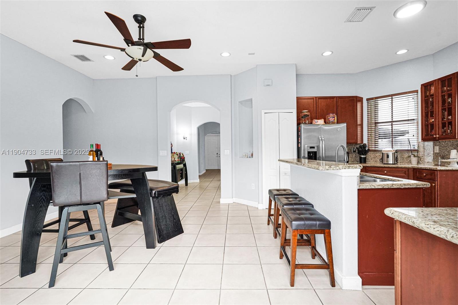 9067 Northwest 182nd Terrace Hialeah, FL 33018 - Photo 11 of 40 a living room with stainless steel appliances kitchen island granite countertop furniture and a view of kitchen