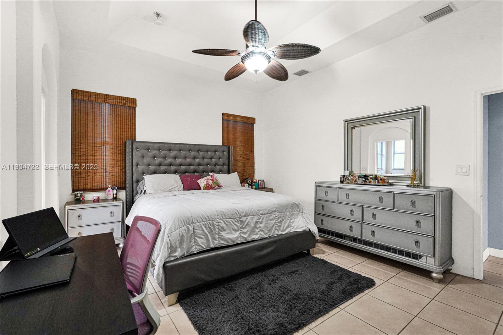 9067 Northwest 182nd Terrace Hialeah, FL 33018 - Photo 15 of 40 a bedroom with a bed and a dresser