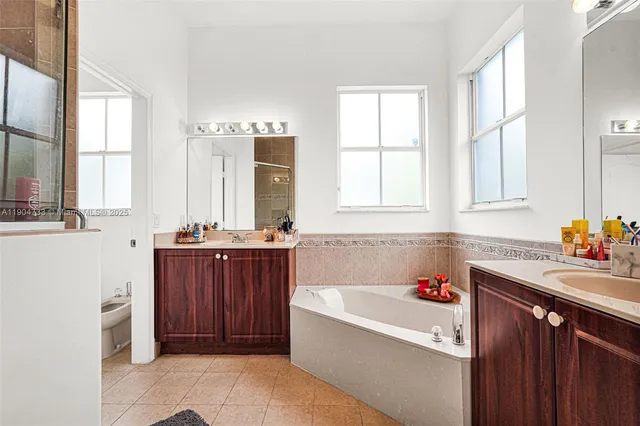 a bathroom with a bathtub sink and window