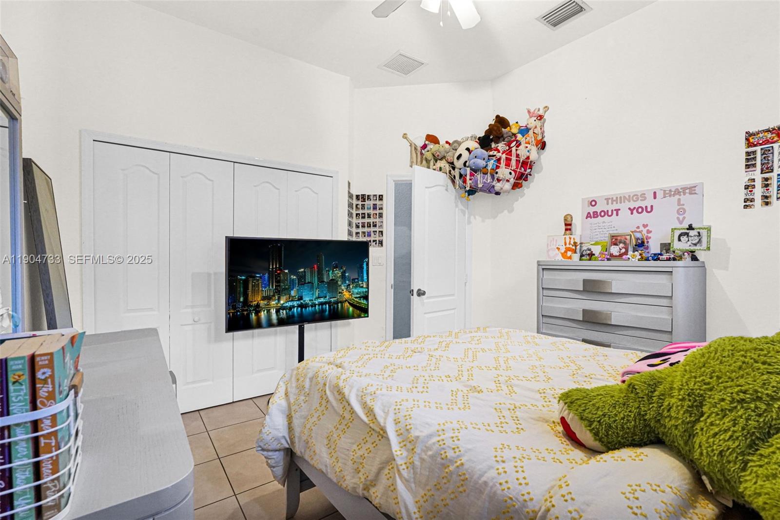 9067 Northwest 182nd Terrace Hialeah, FL 33018 - Photo 20 of 40 a bedroom with a bed painting on wall and a potted plant