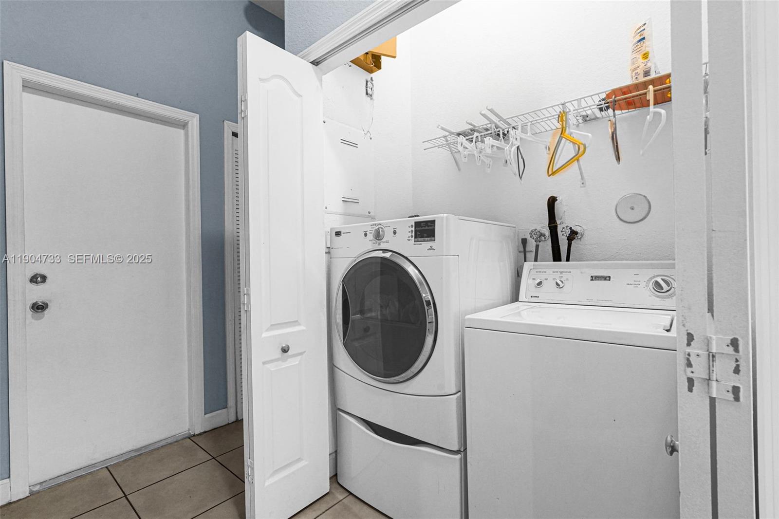 9067 Northwest 182nd Terrace Hialeah, FL 33018 - Photo 22 of 40 a utility room with dryer and washer