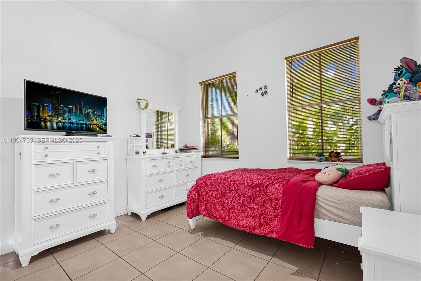 9067 Northwest 182nd Terrace Hialeah, FL 33018 - Photo 27 of 40 a bedroom with a bed and a flat screen tv