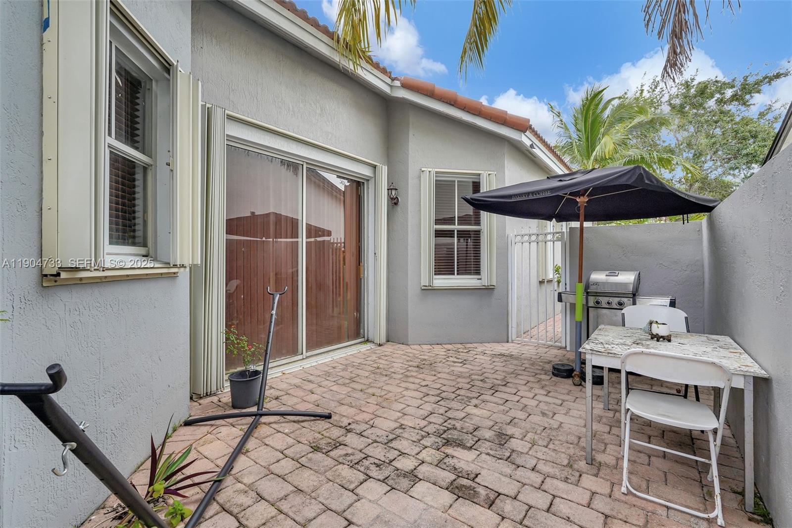 9067 Northwest 182nd Terrace Hialeah, FL 33018 - Photo 28 of 40 a bedroom with a bed and a table