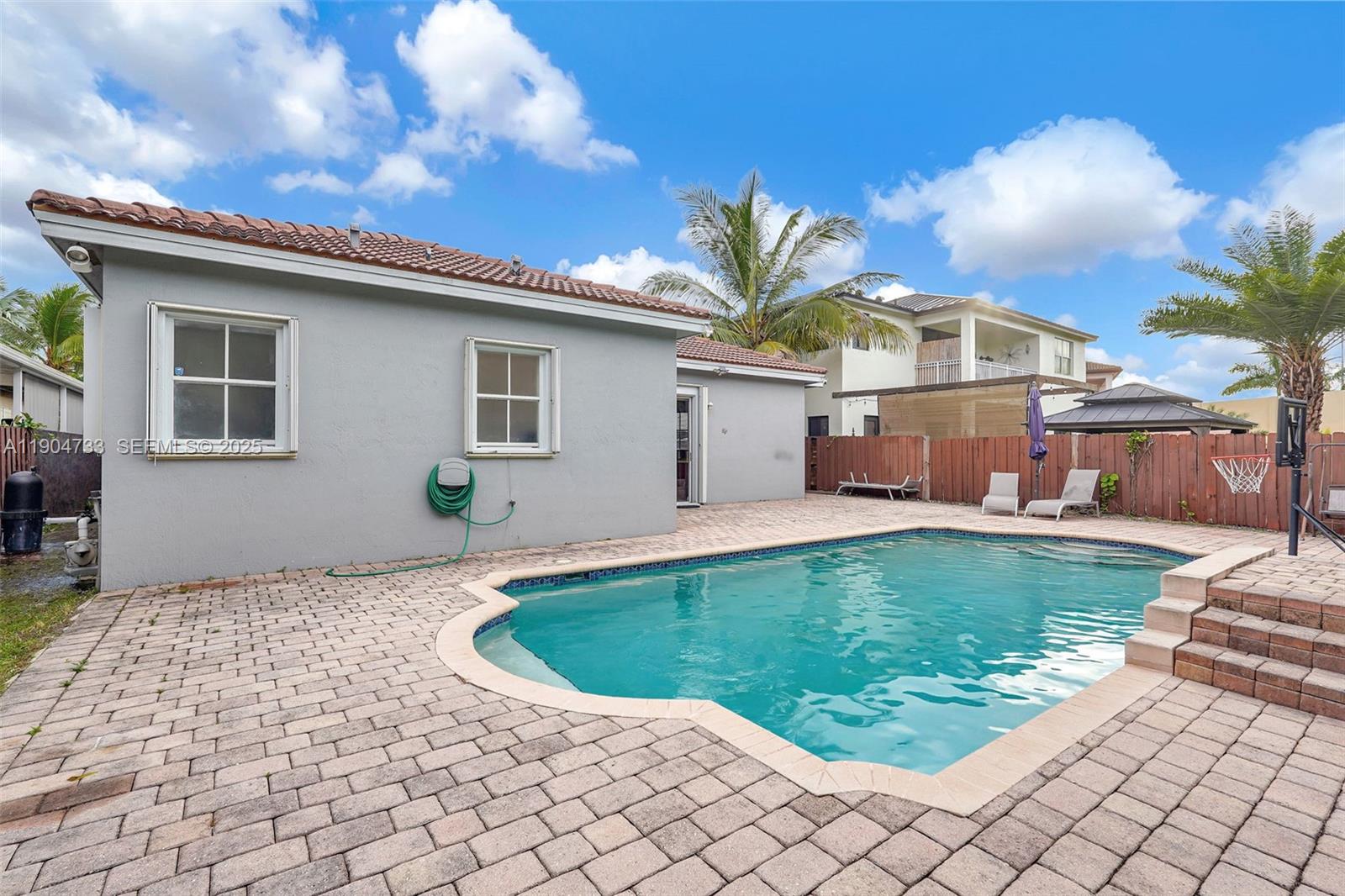 9067 Northwest 182nd Terrace Hialeah, FL 33018 - Photo 33 of 40 a front view of a house with a yard