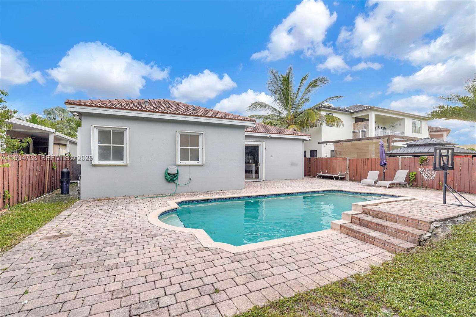 9067 Northwest 182nd Terrace Hialeah, FL 33018 - Photo 34 of 40 a view of a house with backyard porch and sitting area