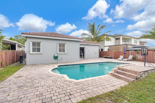 a view of a house with backyard porch and sitting area