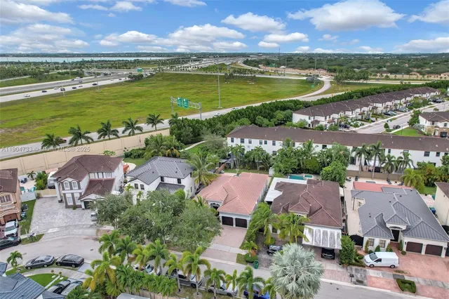 an aerial view of residential houses with outdoor space and ocean view