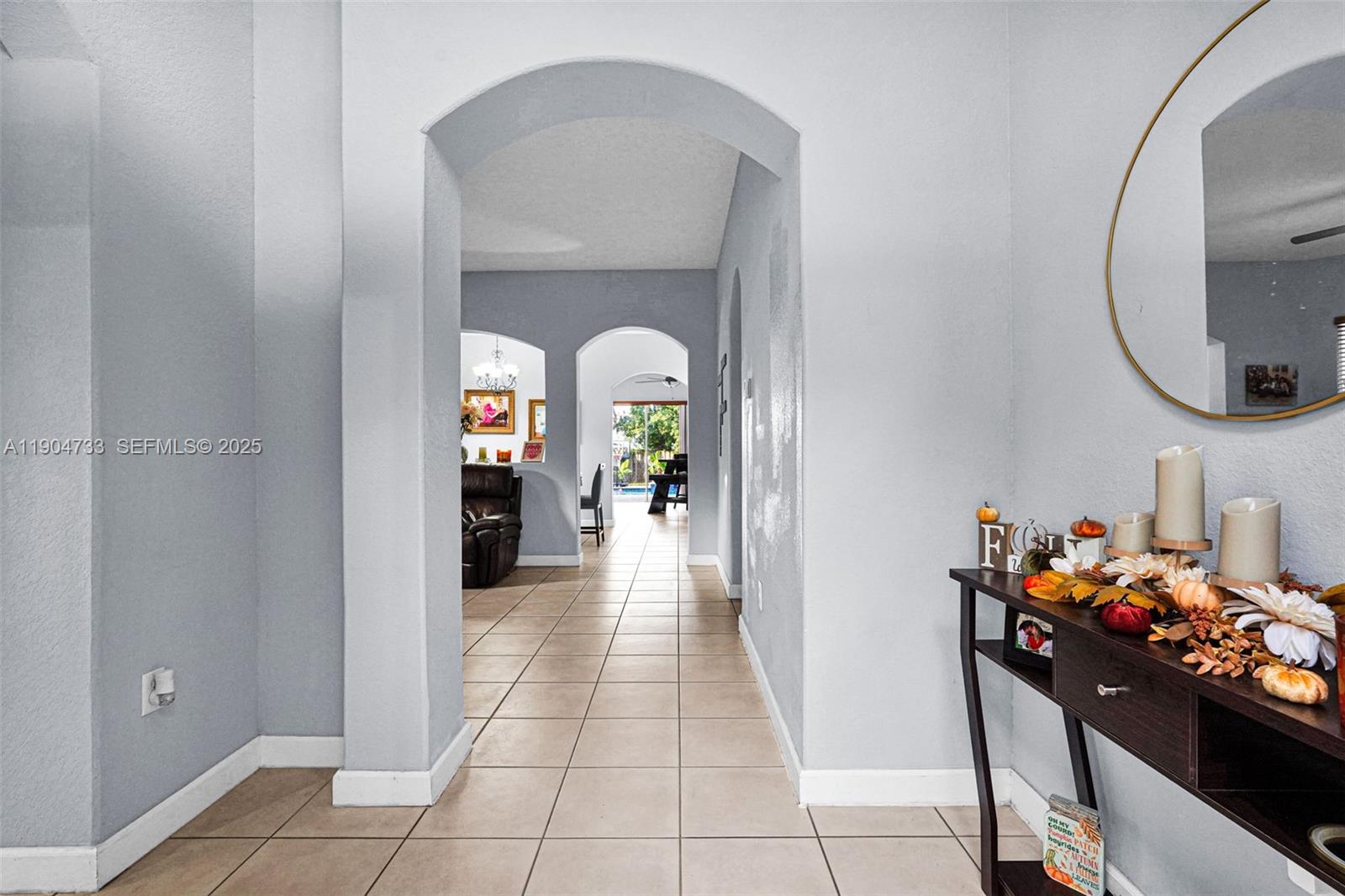 9067 Northwest 182nd Terrace Hialeah, FL 33018 - Photo 5 of 40 a dining room with furniture and a mirror