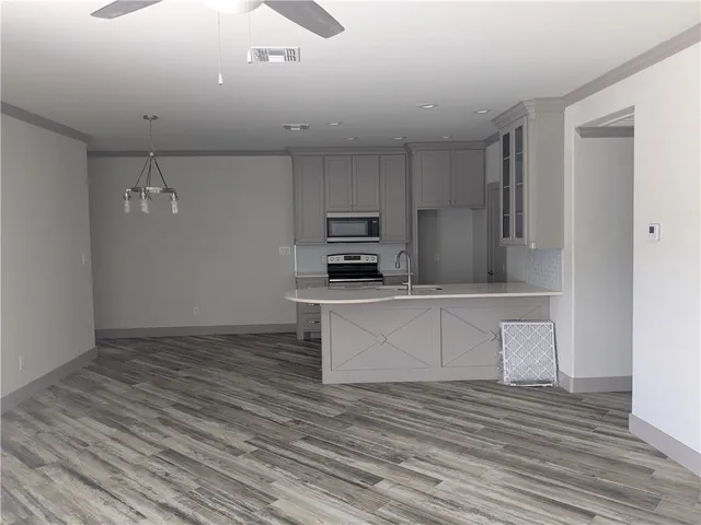 a kitchen with a refrigerator and a stove top oven
