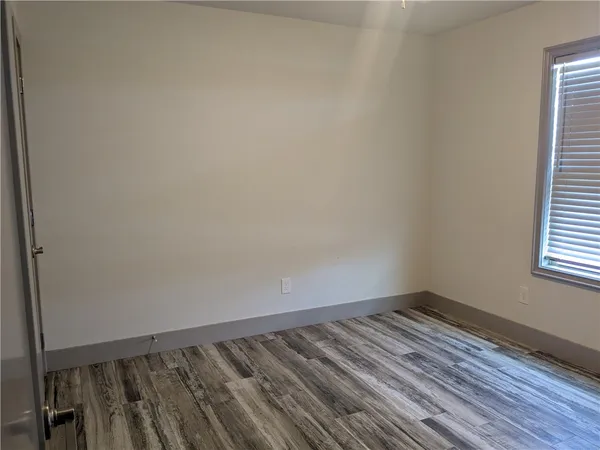 a view of wooden floor and cabinet in a room