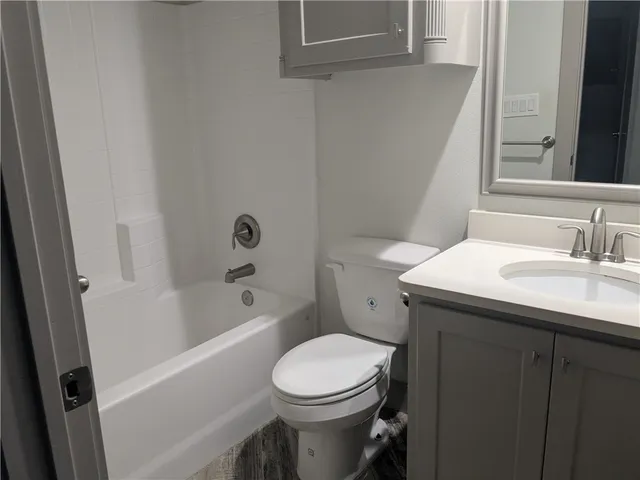 a bathroom with a sink a toilet and bathtub