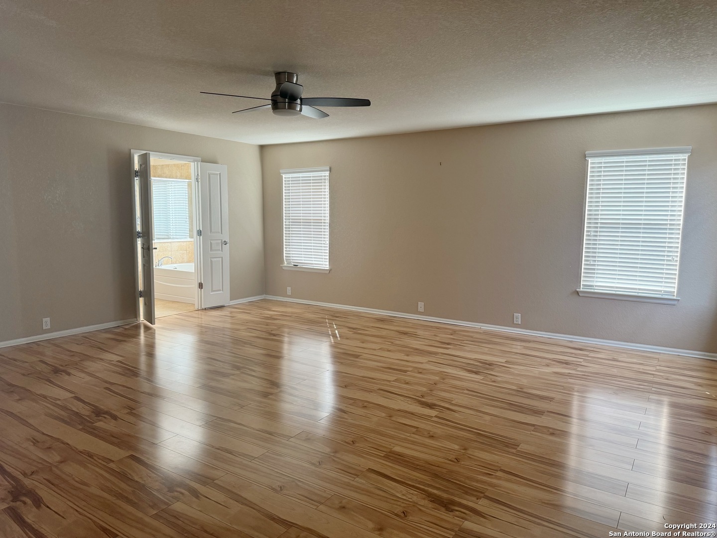 8110 Floating View San Antonio, TX 78255 - Photo 15 of 26 a view of an empty room with wooden floor and a window