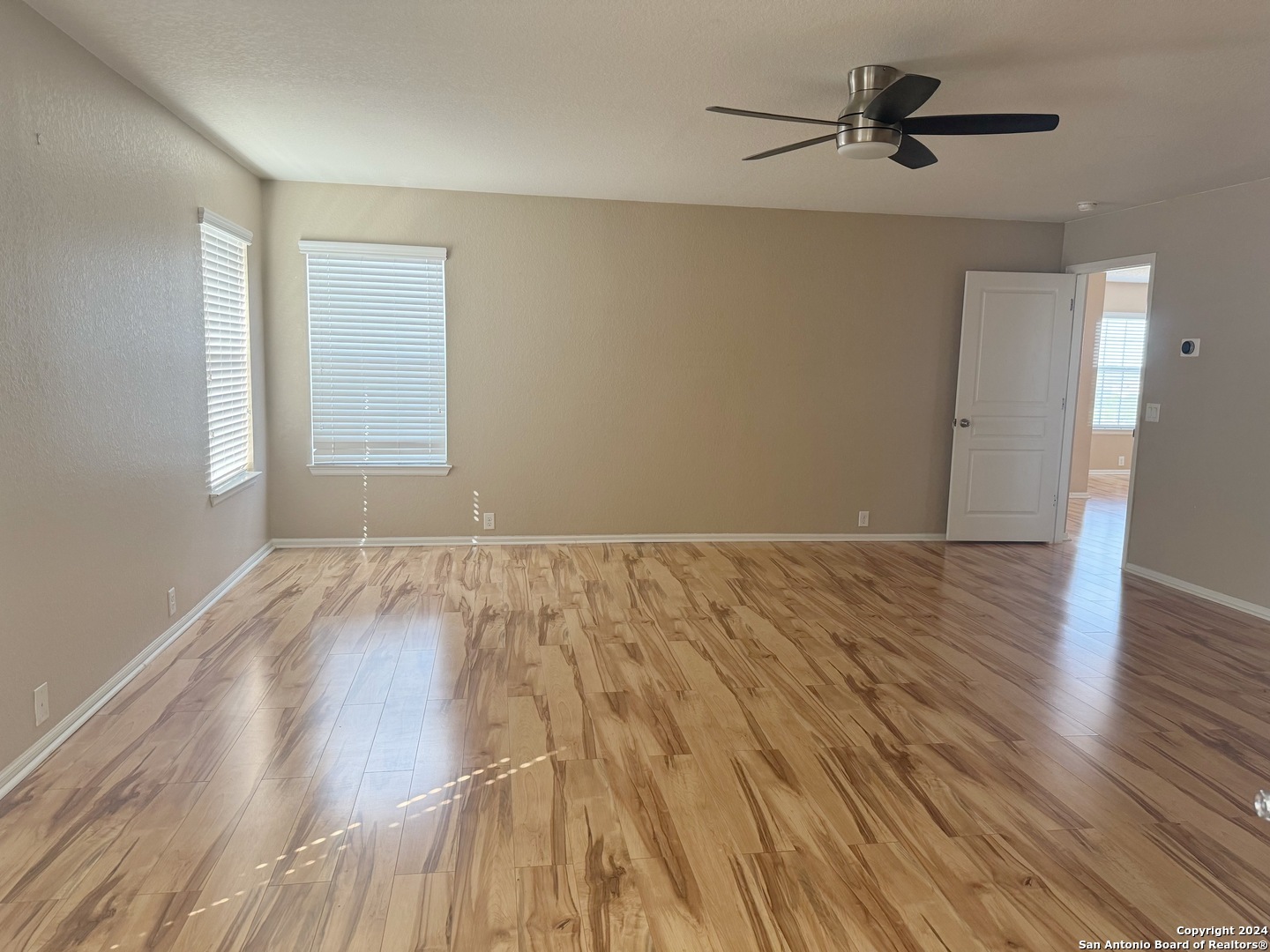 8110 Floating View San Antonio, TX 78255 - Photo 16 of 26 wooden floor in an empty room with a window