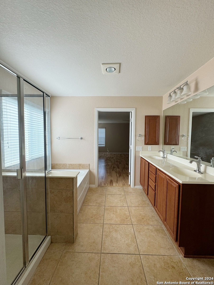 8110 Floating View San Antonio, TX 78255 - Photo 19 of 26 a large kitchen with kitchen island granite countertop a large counter top and sink