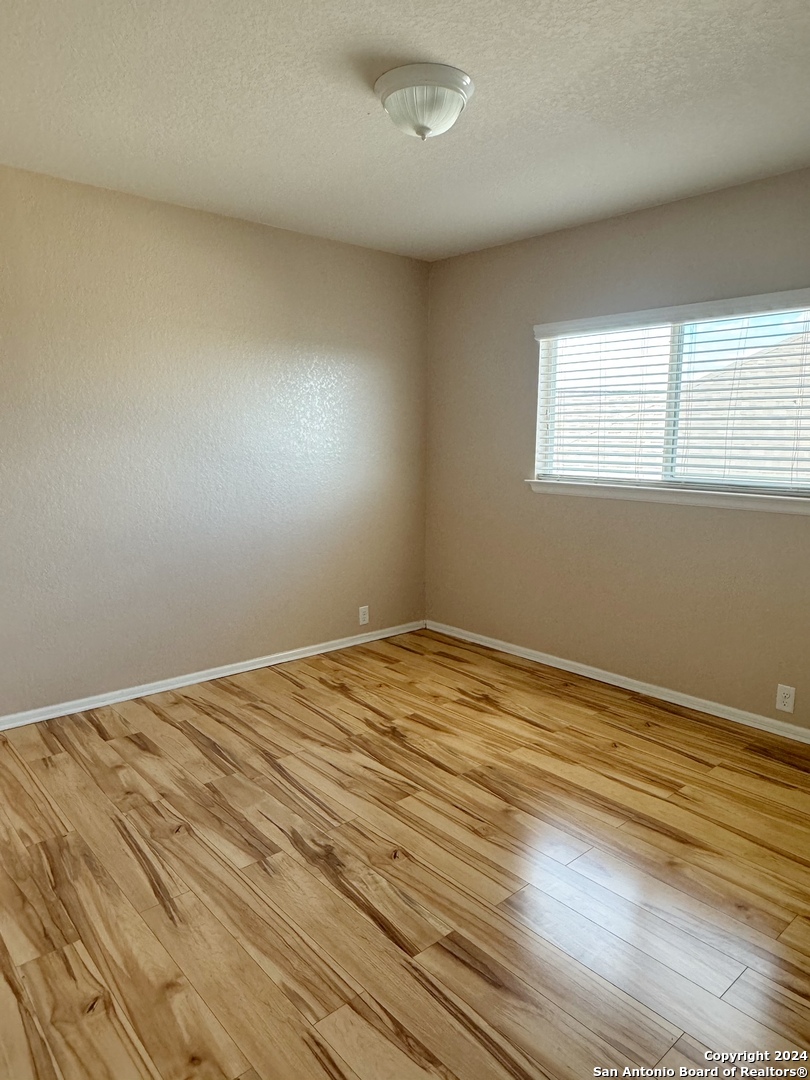 8110 Floating View San Antonio, TX 78255 - Photo 20 of 26 a view of empty room with wooden floor and fan