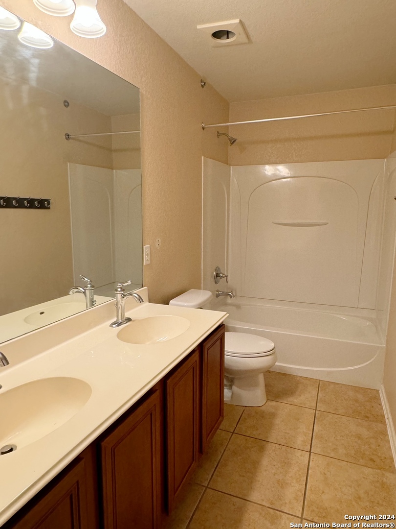 8110 Floating View San Antonio, TX 78255 - Photo 21 of 26 a bathroom with a sink a toilet and shower