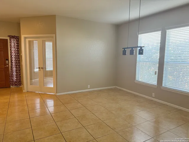 an empty room with windows and closet