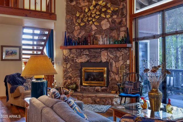 a living room with furniture a flat screen tv and a fireplace