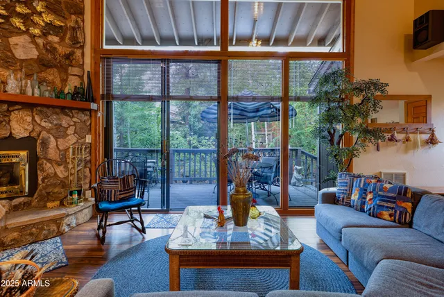 a living room with furniture and a floor to ceiling window