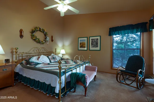 a bedroom with a bed a lamp and a window