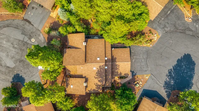 an aerial view of a residential houses with yard